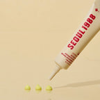 Seoul 1988 cosmetic tube with green product on a beige background