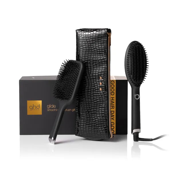 Hair styling tools including a brush, hair dryer, and comb with ghd branding on a white background.