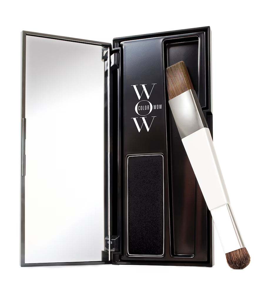 Makeup product with brush and mirror in a black case on a white background