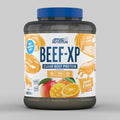 Applied Nutrition Beef-XP protein powder container with orange and mango flavor on a gray background