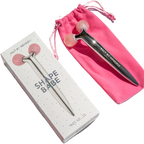 Facial roller with packaging and pink pouch on a white background