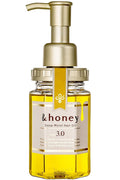 Bottle of &honey Deep Moist Hair Oil with a pump on a white background