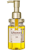Bottle of &honey Deep Moist Hair Oil with a pump on a white background