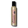 Hair product bottle with a pink label on a white background
