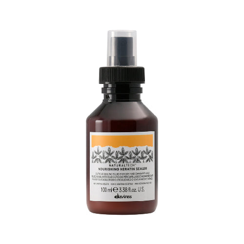Bottle of Davines hair product on a white background