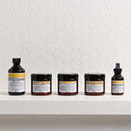 Set of Davines hair care products on a white shelf with a white tiled wall background