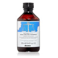 Bottle of Davines Naturaltech Rebalancing Shampoo on a white background