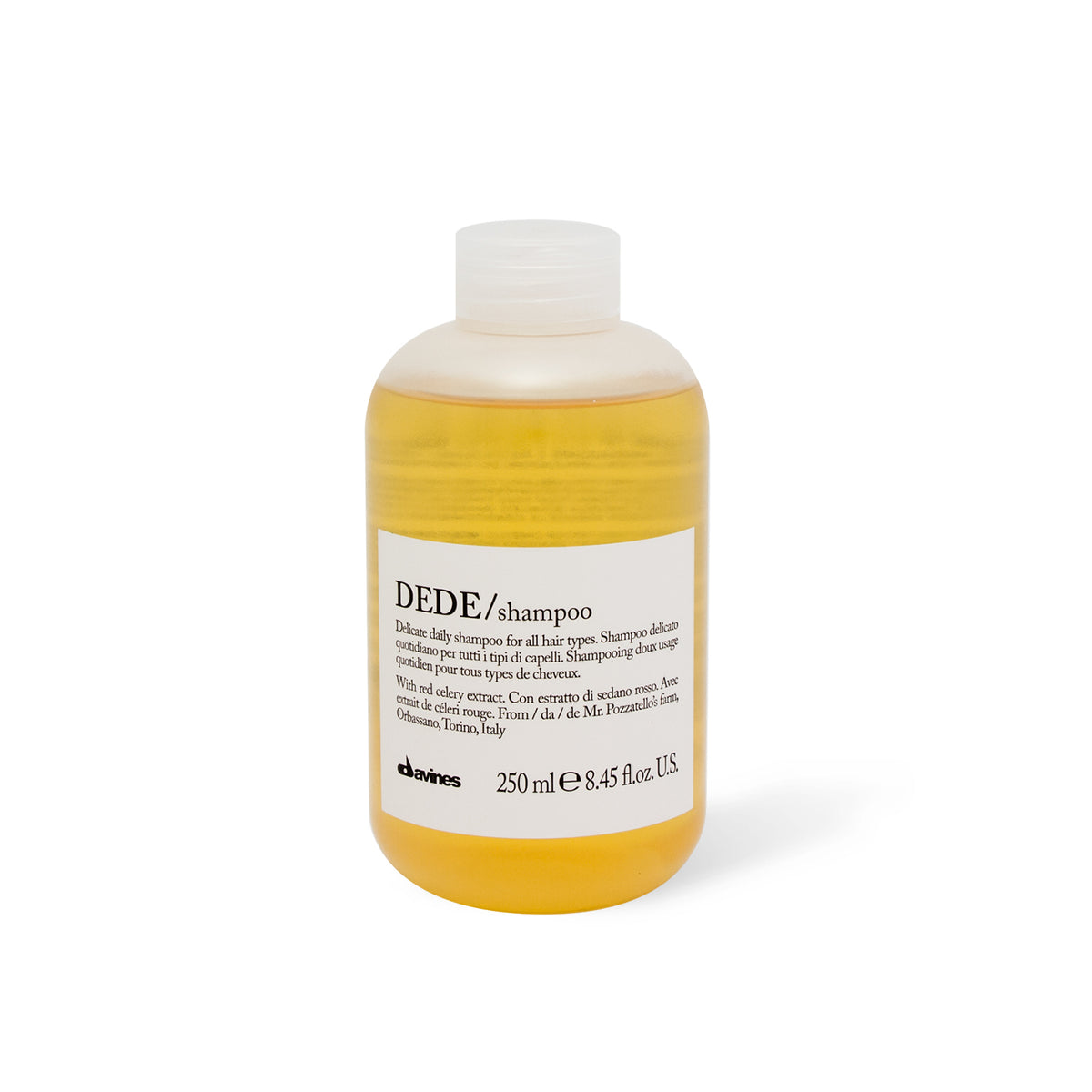 A bottle of Davines DEDE SHAMPOO with a capacity of 250 ml. The shampoo appears to have a yellow or golden hue.