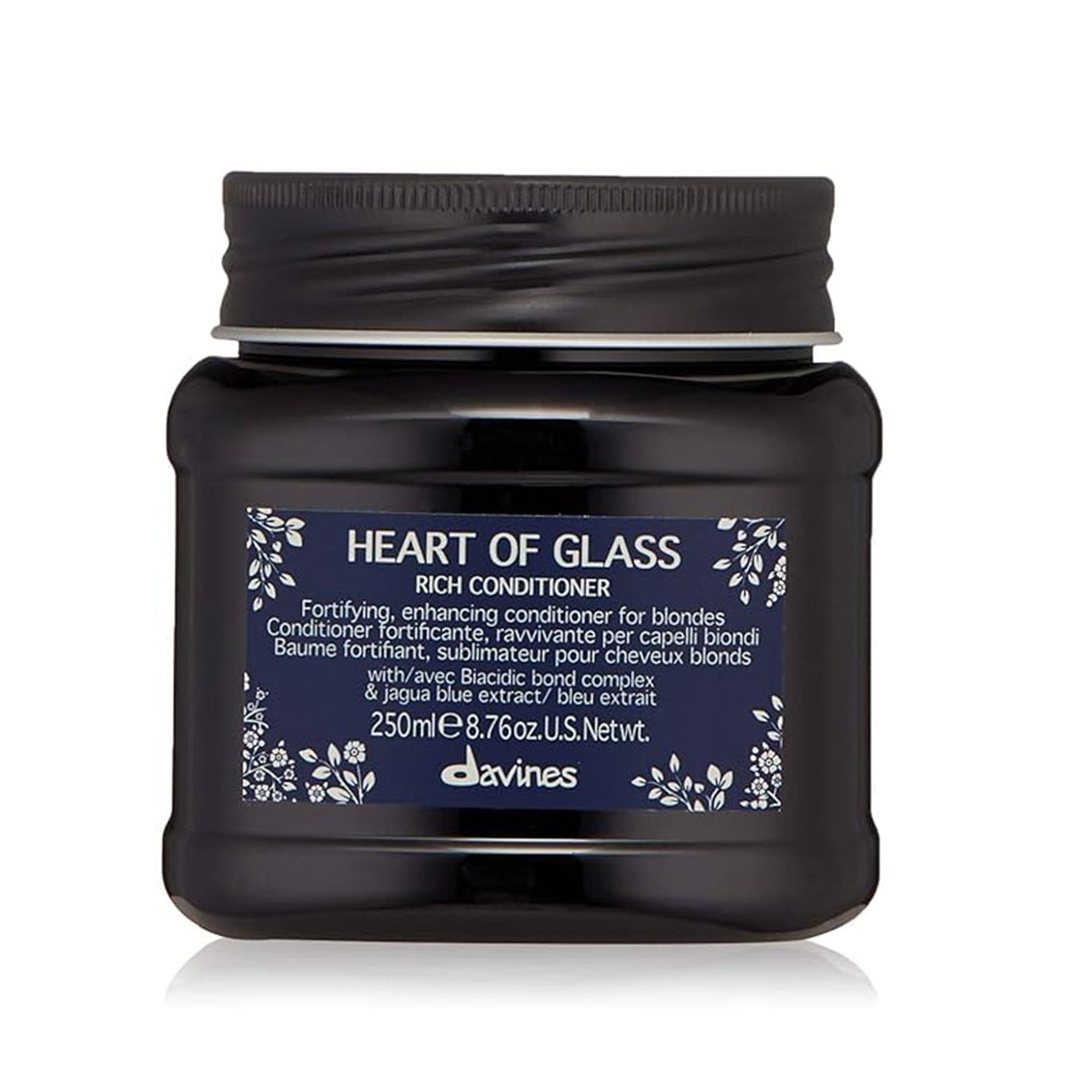 A jar of Davines HEART OF GLASS CONDITIONER, 250 ml size, with a black label and floral designs.