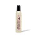 A bottle of Davines VOLUME BOOSTING MOUSSE with a white label on it, indicating that it's a product designed for adding volume to hair.
