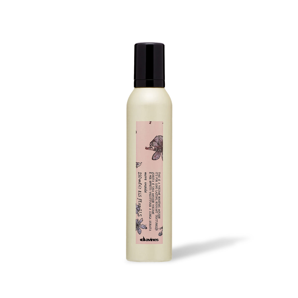 A bottle of Davines VOLUME BOOSTING MOUSSE with a white label on it, indicating that it's a product designed for adding volume to hair.
