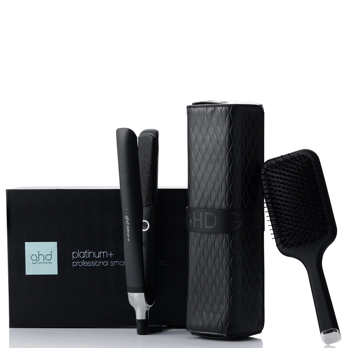 ghd hair styling tools including a straightener, curler, and brush on a white background