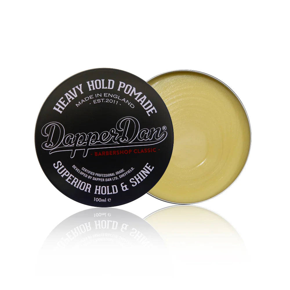 Dapper Dan heavy hold pomade container with black lid and gold body on a white background