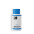 A bottle of K18 Damage Shield Protective Conditioner, 250ml, with a predominantly blue cap and a white and blue label.