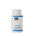 A bottle of K18 Damage Shield Protective Shampoo, 250ml, with blue and white labeling.