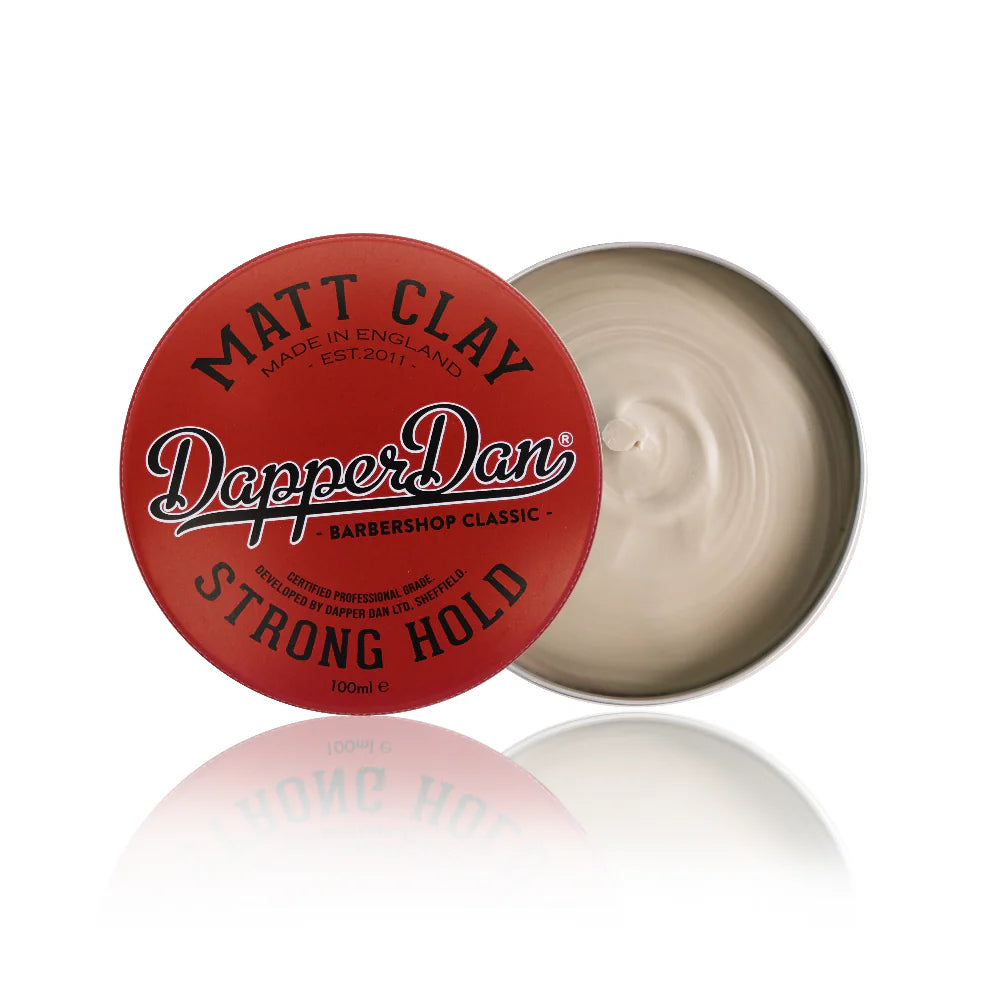 Dapper Dan hair product with red lid and white cream inside on a white background