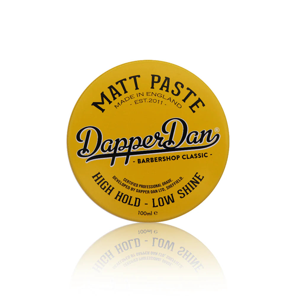 Yellow container of Dapper Dan Matt Paste on a white background