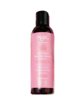 Nuxe bottle with pink label surrounded by flowers on a light background