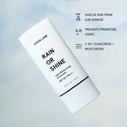 Jaxon Lane Rain or Shine Daily Moisturizing Sunscreen SPF 50+ / PA+++ in a white squeeze tube, shown on a soft light blue background with black text callouts about sun damage, aging prevention, and dual sunscreen moisturizer benefits.