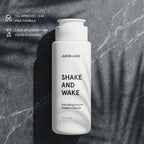 Jaxon Lane 'Shake and Wake' exfoliating enzyme powder cleanser bottle on a textured gray background