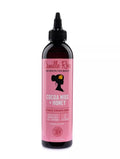 Camille Rose Cocoa Nibs + Honey serum bottle on a white background