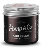 A jar of Pomp & Co. Hair Cream with a matte black label and a silver metal lid, shown on a clean white background.