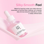 A pink skincare dropper bottle labeled 'Pore Firming Serum Red Bean PDS + Peptide' resting on a soft pink fabric surface, with promotional text above reading 'Silky-Smooth Feel.'.