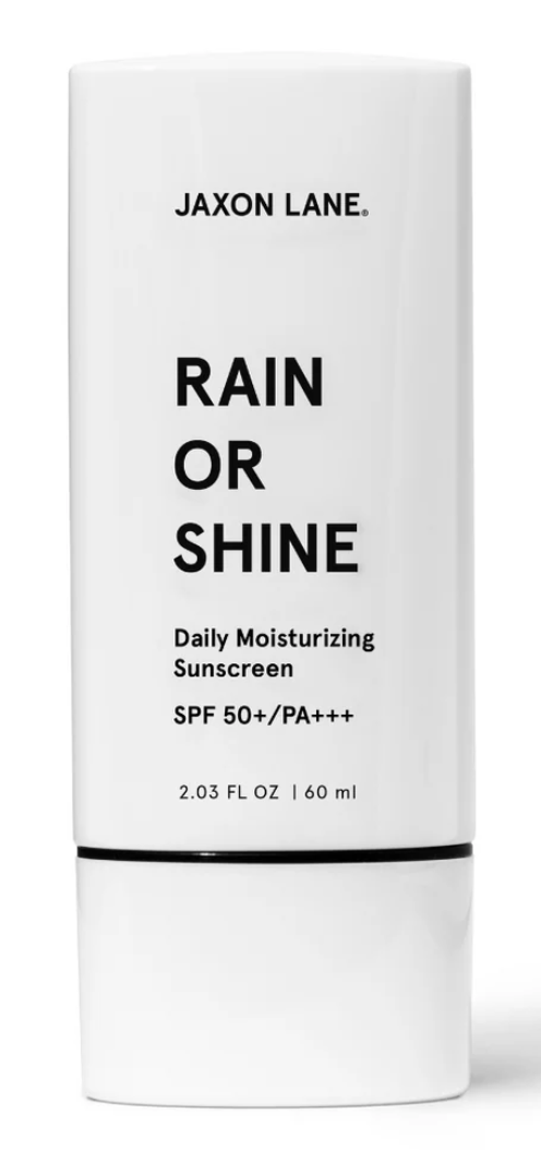 A white cylindrical tube of Jaxon Lane Rain or Shine Daily Moisturizing Sunscreen, SPF 50+/PA+++, with black text on a clean white background.
