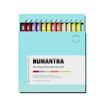 Box of Humantra zero sugar electrolyte drink mix with colorful packets on a light blue background