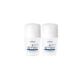 Two Vichy deodorant bottles on a white background