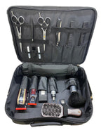Open black case containing grooming tools including scissors, clippers, and brushes on a white background