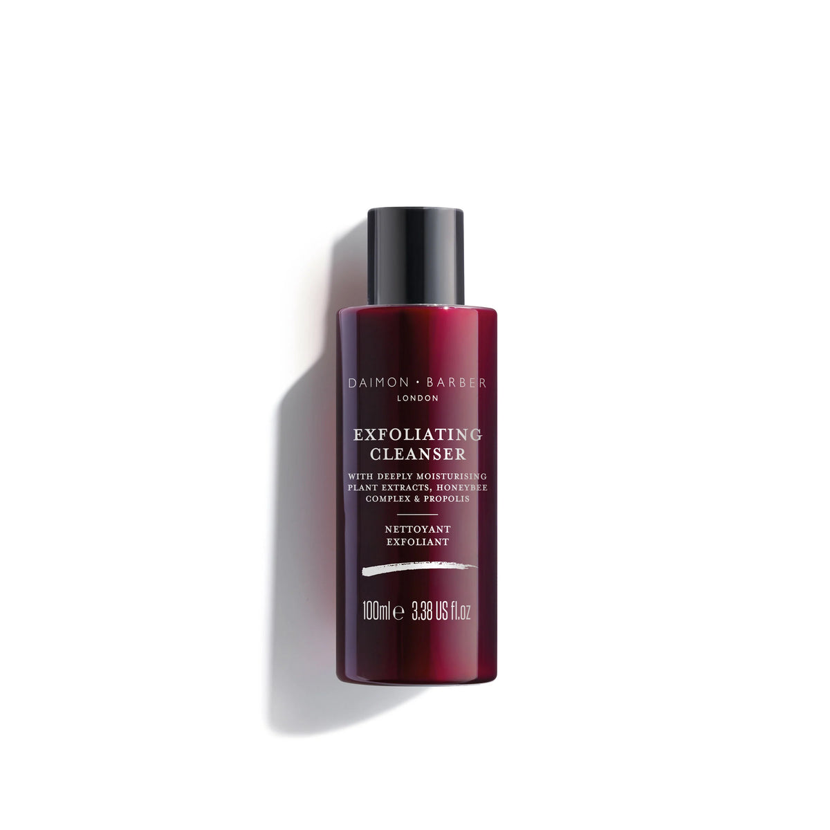 Red bottle of Exfoliating Cleanser by Damon & Barber on a white background