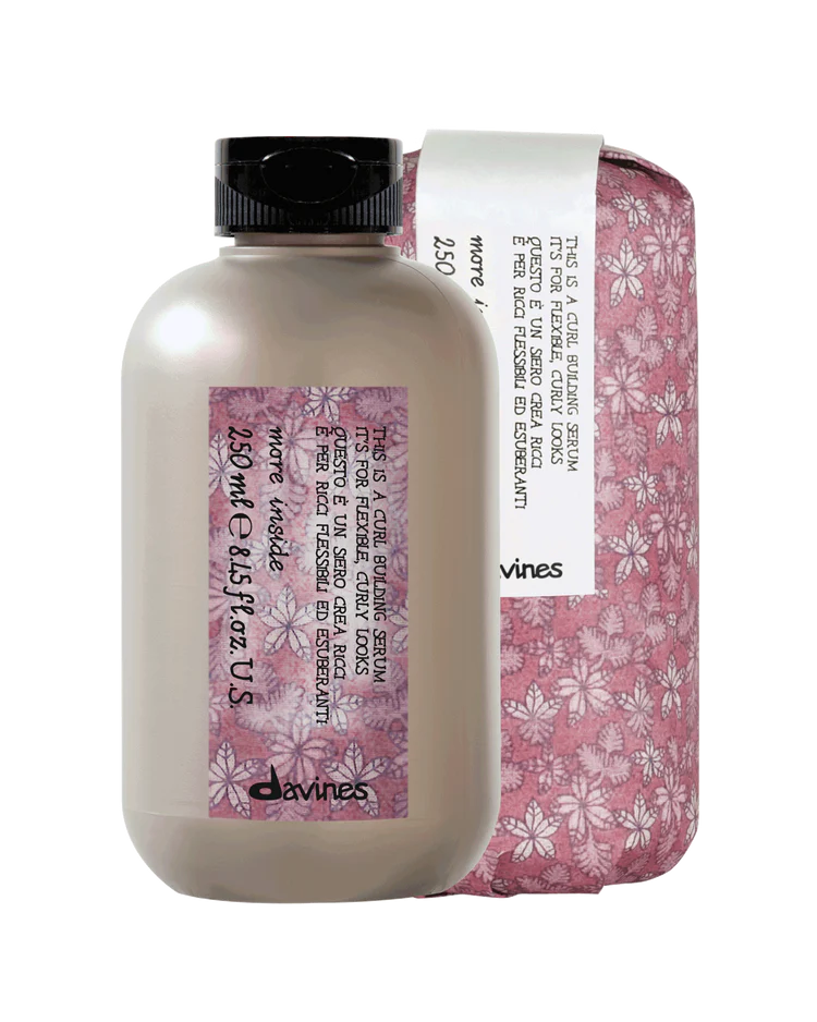 Davines hair product bottle with pink floral packaging on a white background
