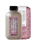 Davines hair product bottle with pink floral packaging on a white background