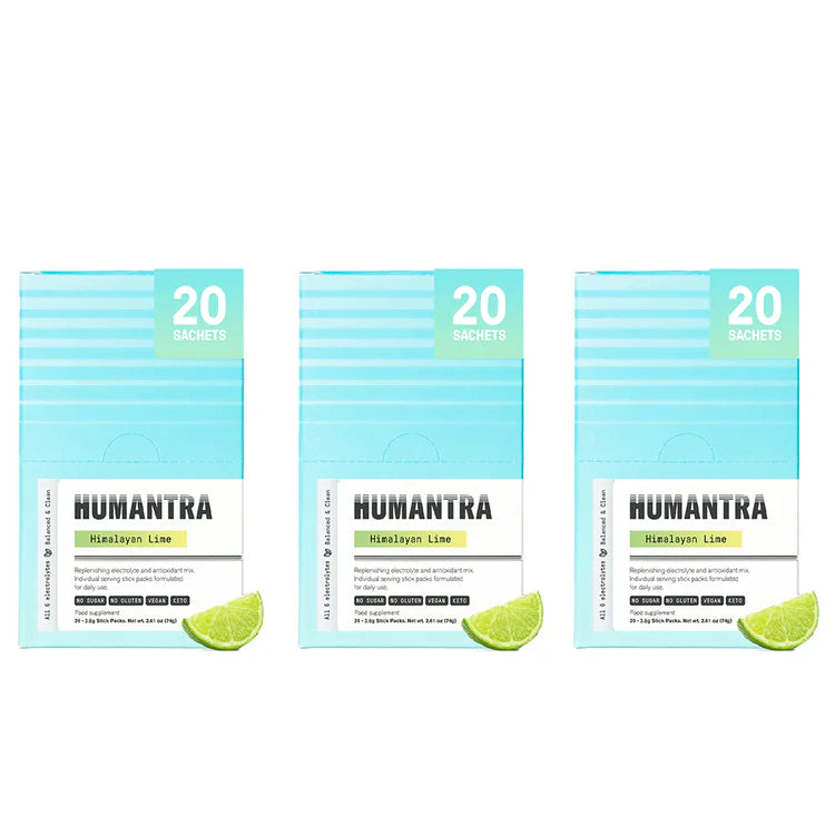Three packages of Humantra with lime slices on a white background