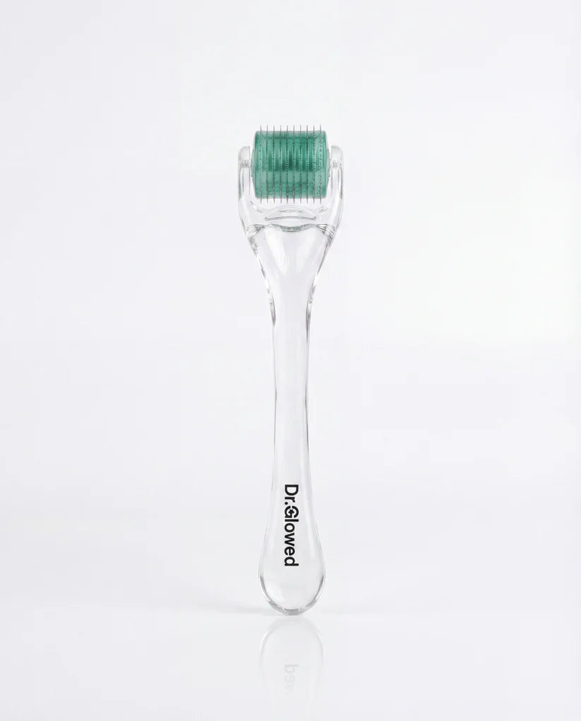 A clear plastic derma pen with a green and white roller head, featuring the black printed brand name 'Dr.Glowed' on the handle, set against a clean white background.