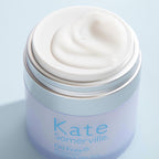 Jar of Kate Somerville cream on a light blue background