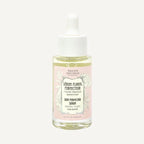 Skincare serum bottle with pink label on a white background